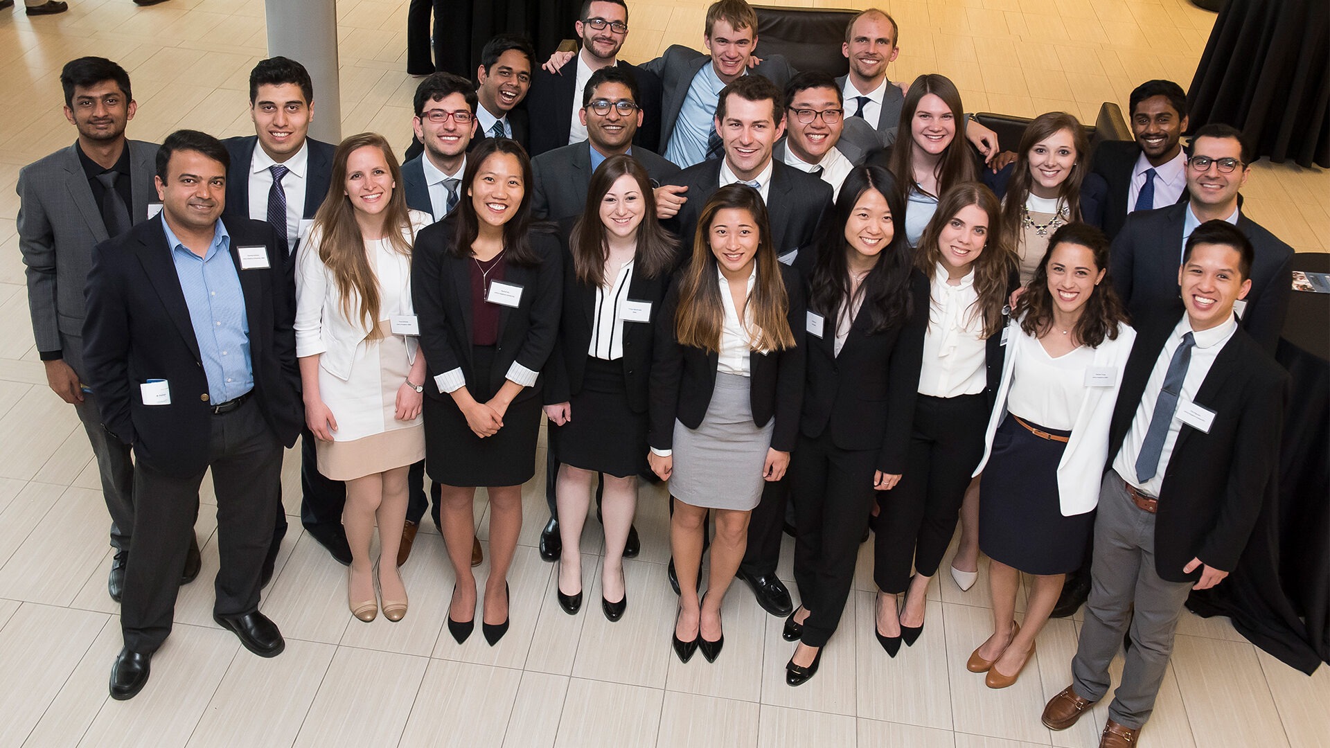 A group of master's students are in a group smiling at the camera.