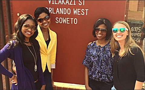 The teammates pose for a photo wearing sunglasses.