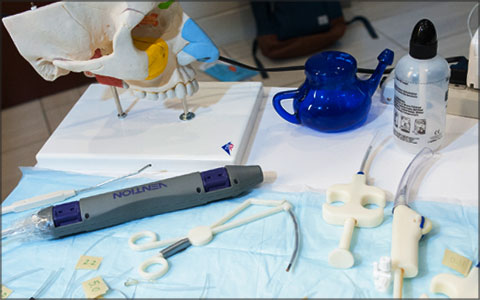 The prototype sits on a table with other medical devices.