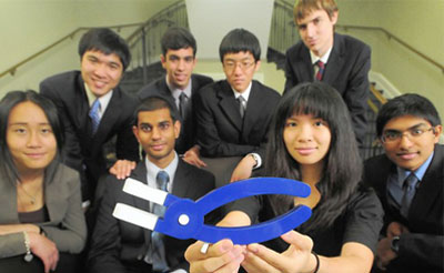 A group of students gather for a photo with their prototype.