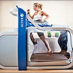 A woman is running on a treadmill.