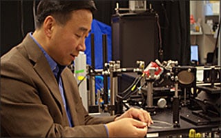 Xingde Li works in his microscope lab.