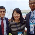 Three students stand together for a picture.