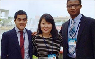 Three students stand together for a picture.