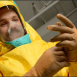 A man tries on the yellow ebola suit.