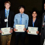 Students gather for a group photo holding their awards.