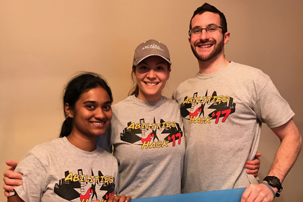 The team of students pose for a photo wearing matching t-shirts.