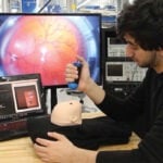 A male student demonstrates the device in the Design Studio.