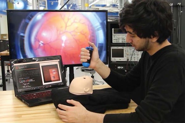 A male student demonstrates the device in the Design Studio.