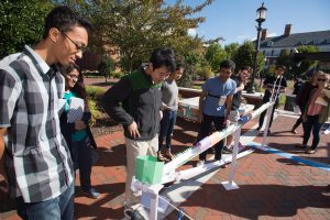 Student demonstrate their device outside.