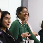 Young female researchers discuss career topics in a group.