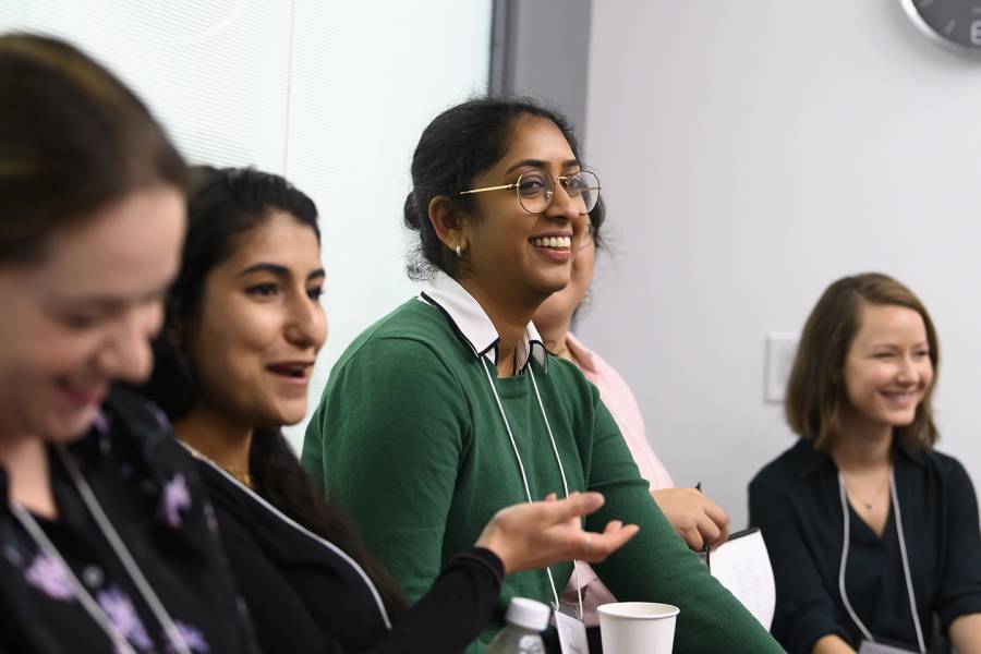 Young female researchers discuss career topics in a group.