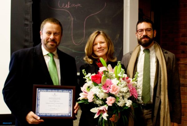 Eileen Haase receives an award from the Dean.