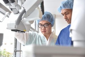 Noah Yang works with a device in the hospital.