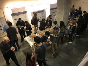 Students and faculty enjoy food and posters during the interactive reception.