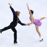 Two figure skaters are skating together on the ice.