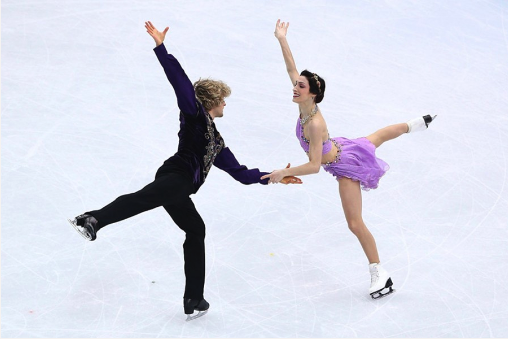 Two figure skaters are skating together on the ice.