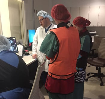 Students and a clinician work together in the hospital.