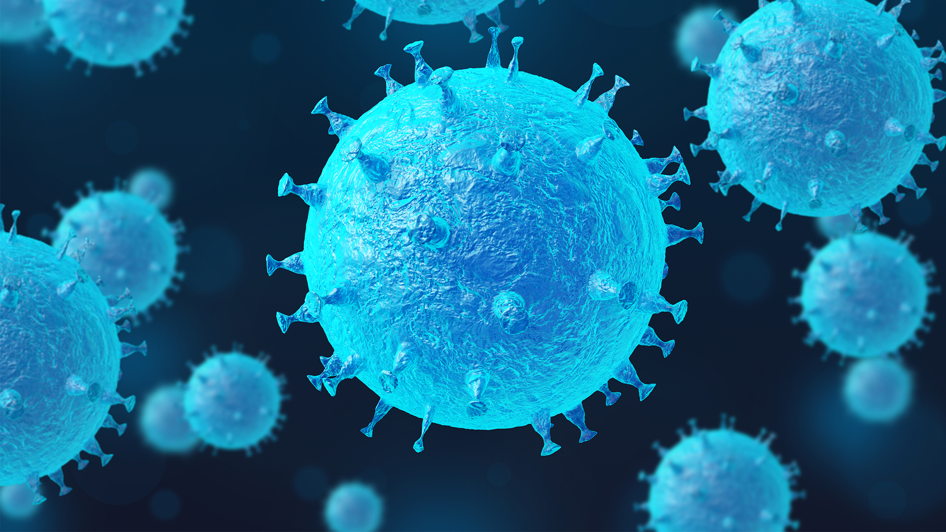 Light blue, spiky spheres float amongst a dark blue background, which is meant to represent a virus in the body.