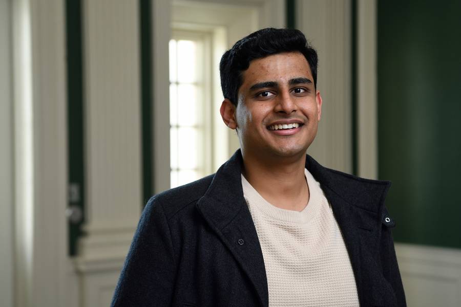 Shubhayu Bhattacharyay smiles for the camera wearing a white shirt and a dark jacket.