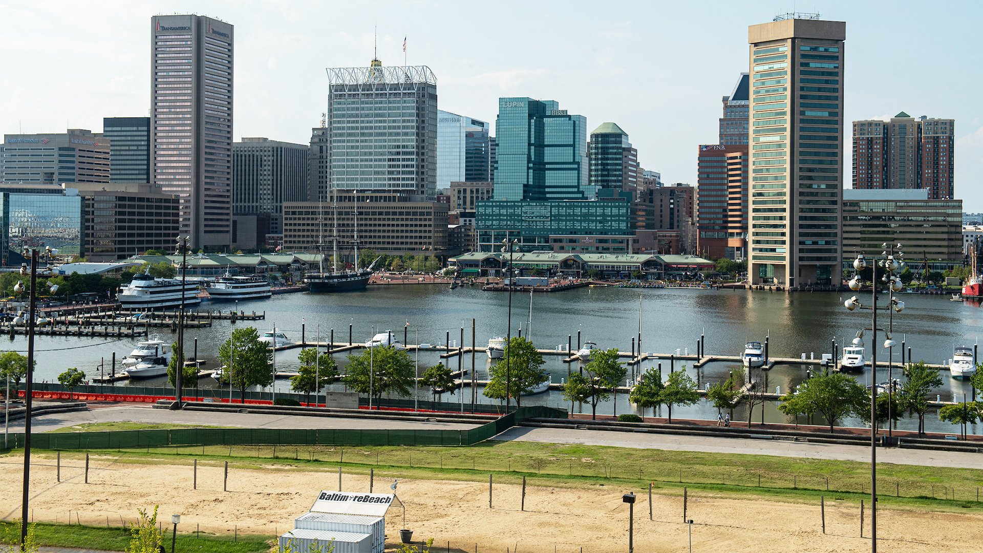 Tall buildings in downtown Baltimore are shown behind the inner harbor.