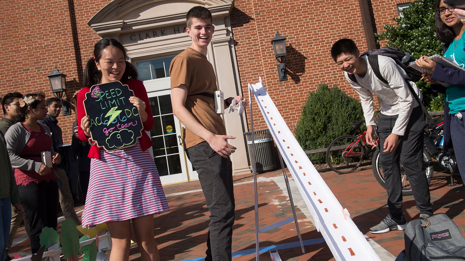 Students are outside of Clark Hall working on their foam core design challenge.