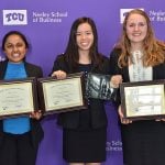 The woman of Team Relavo stand together holding awards.