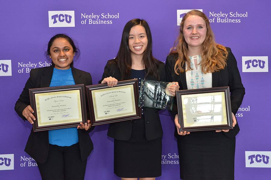 The woman of Team Relavo stand together holding awards.