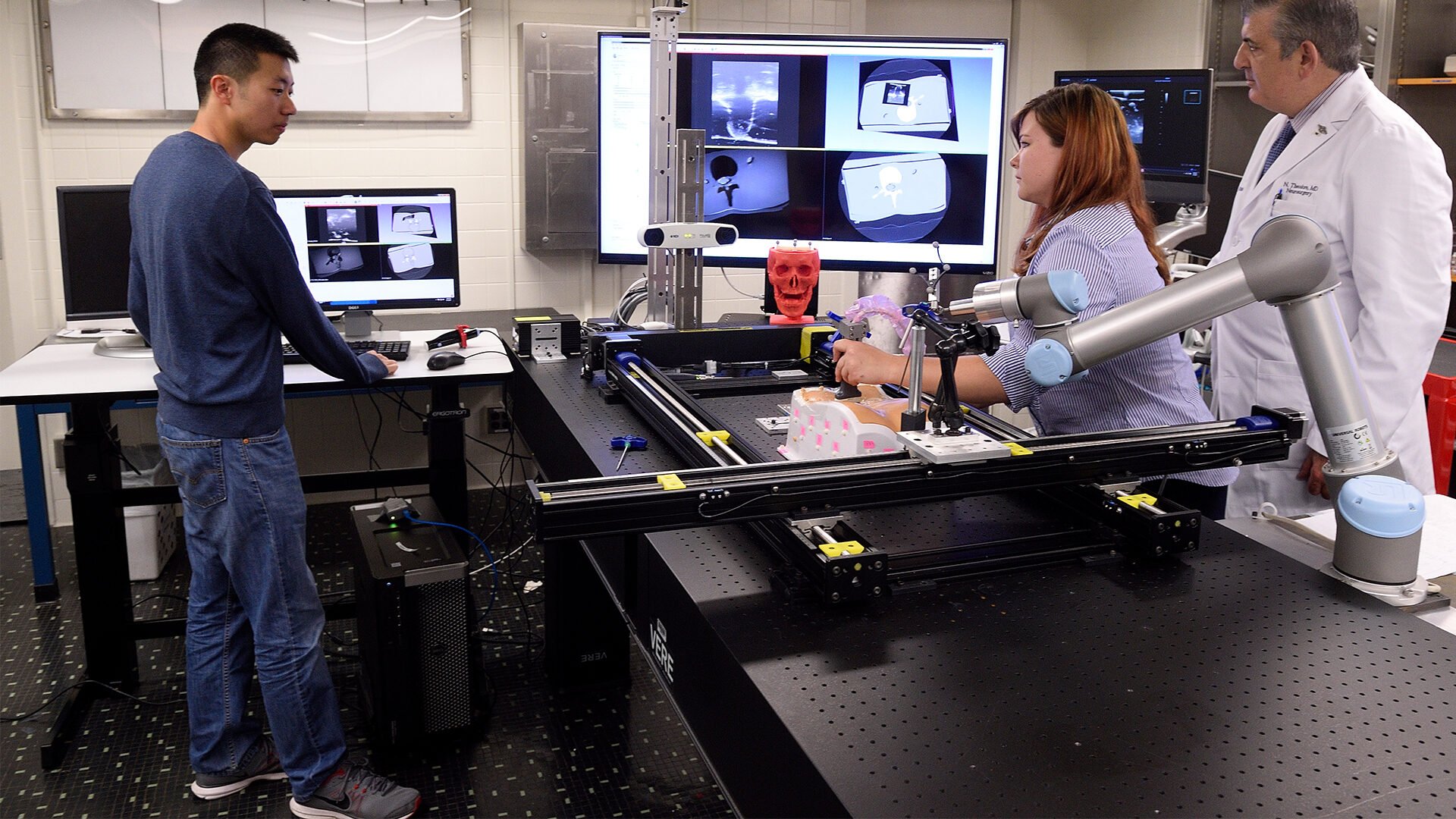 A wide shot of an imaging lab with three people working.