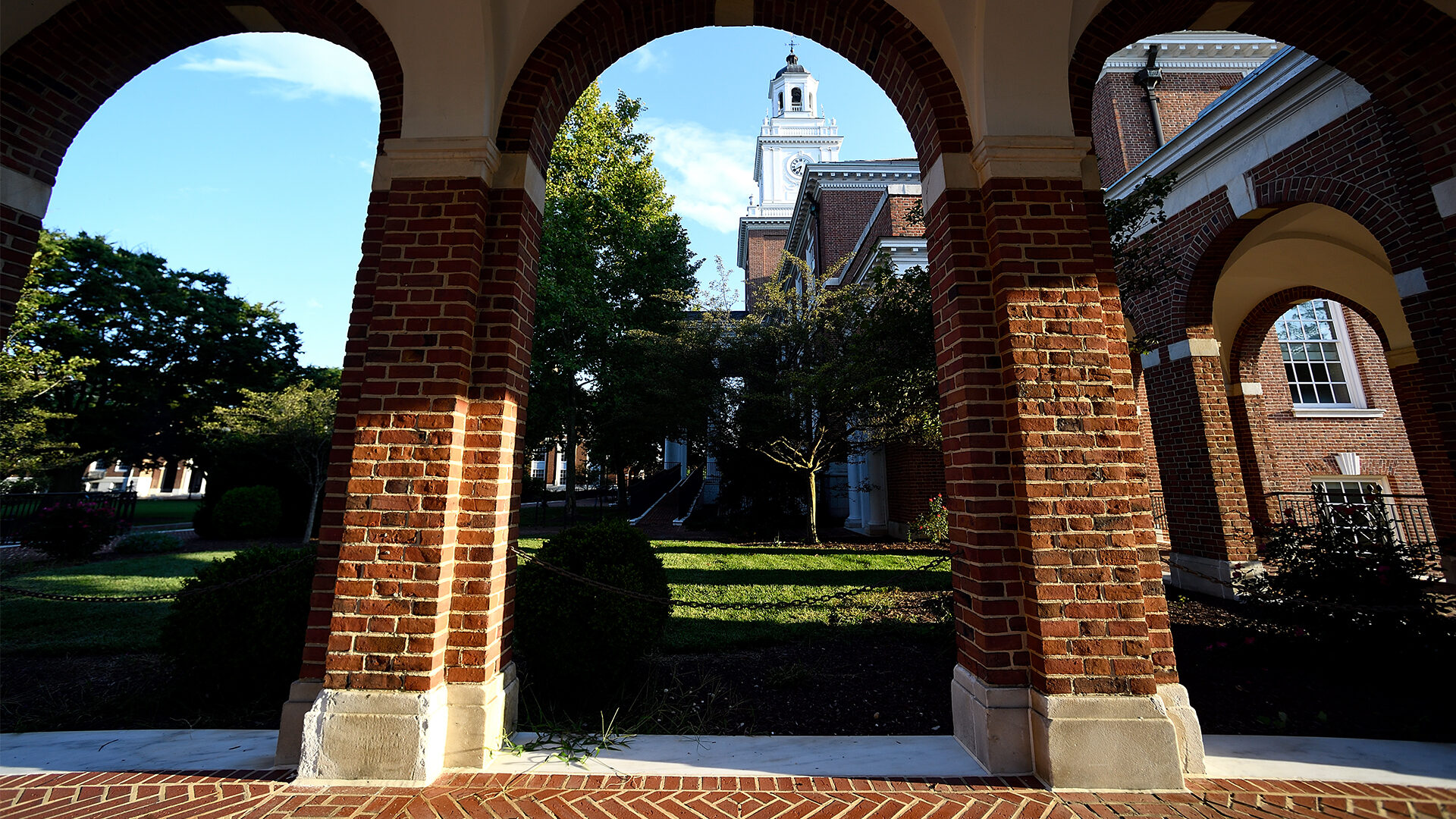 Three brick arches are shown with a tower in the background.