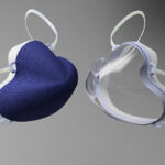 A mask with a blue front is shown next to a mask with a clear front.