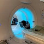 A CT scanner has a uv light shining on the inner bore.