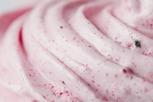 A close-up shot of pink ice cream with circular lines in it.