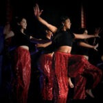 A group of women are performing an Indian dance.