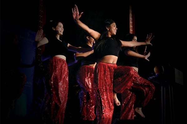 A group of women are performing an Indian dance.