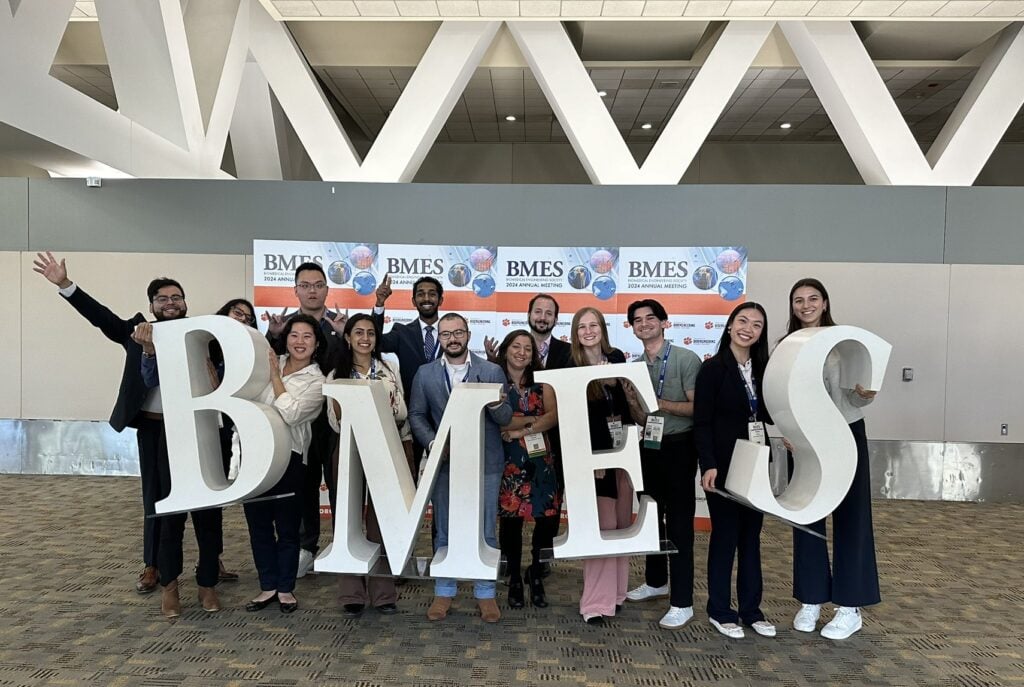 A group of people pose with a BMES sign.