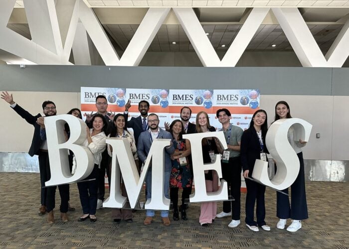 A group of people pose with a BMES sign.