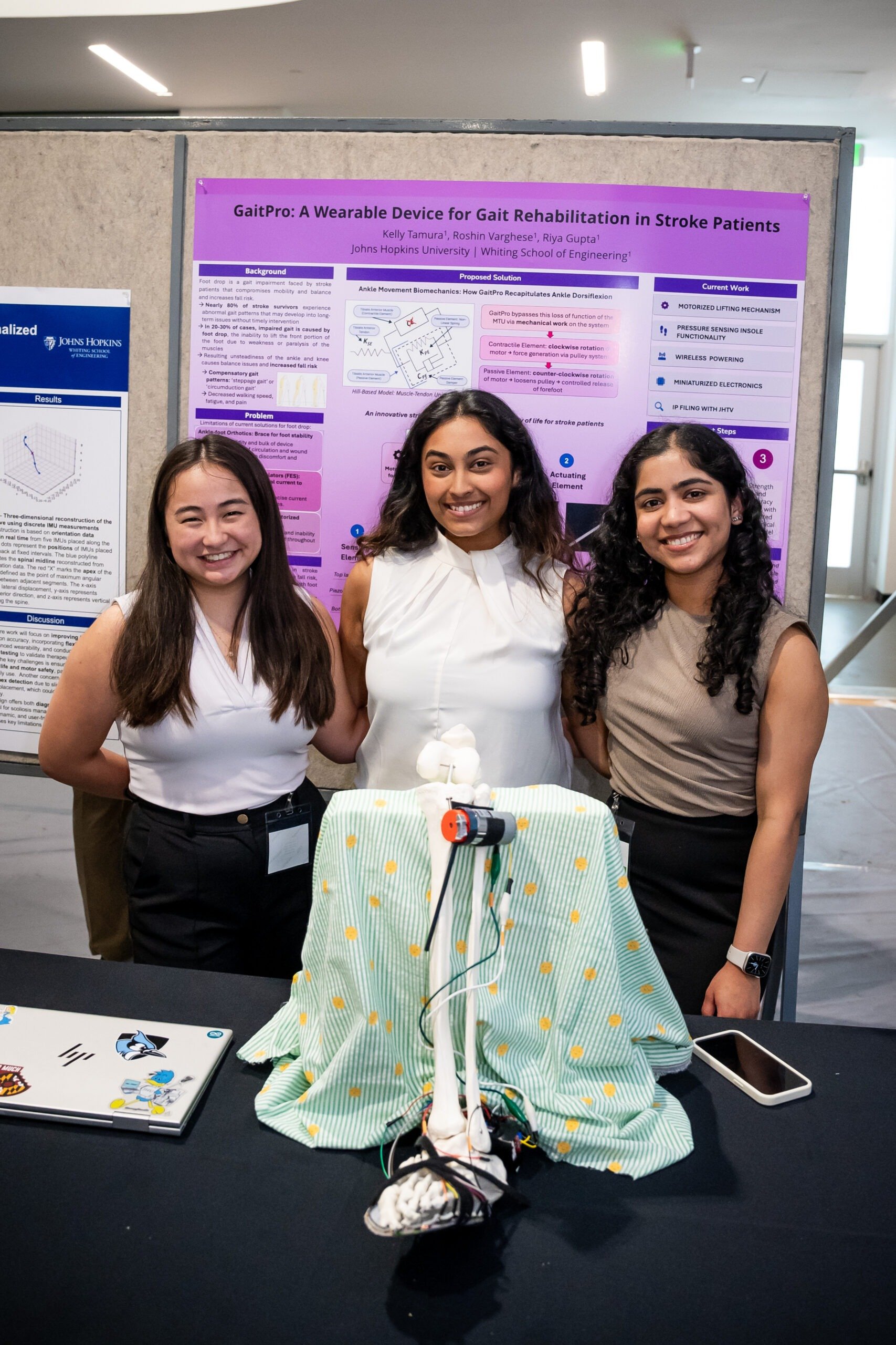 Team members Kelly Tamura, Riya Gupta, and Roshin Varghese with GaitPro device