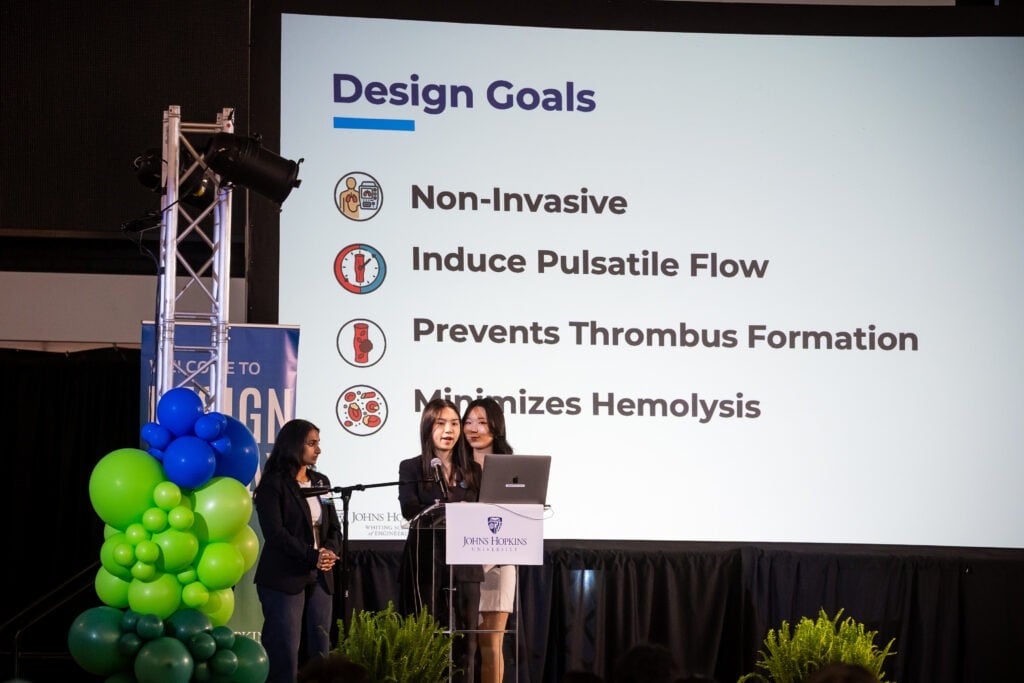 A student team presents on stage.