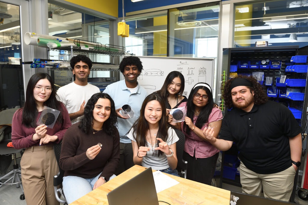 Team of students smiling together in the design studio