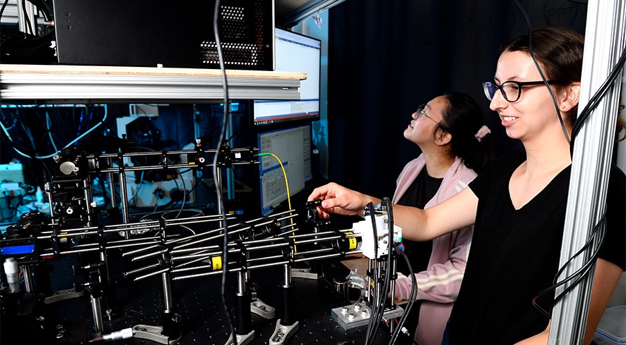 Two female students are working in a lab.